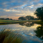 Sunrise view from Cassique Club Cottages looking over pond and the 18th green of Cassique Golf Course